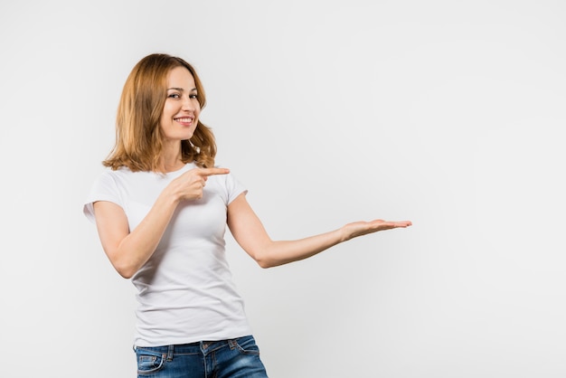 Young woman presenting something against white background Photo | Free ...