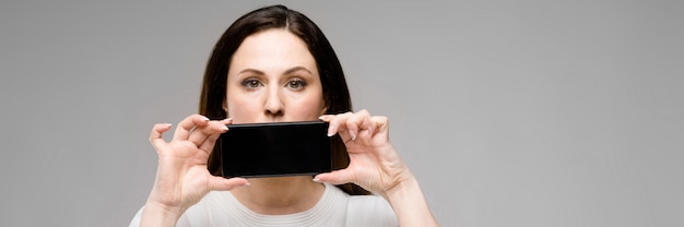 Young woman presenting telephone Premium Photo