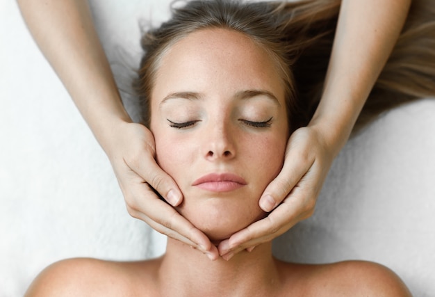 Young Woman Receiving A Head Massage In A Spa Center Photo Free Download