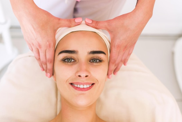 Premium Photo Young Woman Receiving A Head Massage In A Spa Center