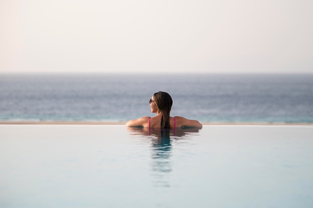 Free Photo | Young woman relaxing alone in the pool