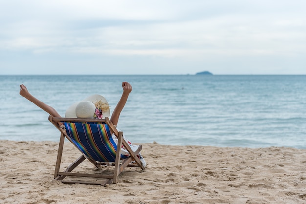 Young Woman Relaxing On The Beach Chair Summer Vacation Holidays Trip Premium Photo