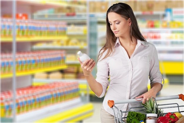 Premium Photo | Young woman shopping in grocery store with shopping cart