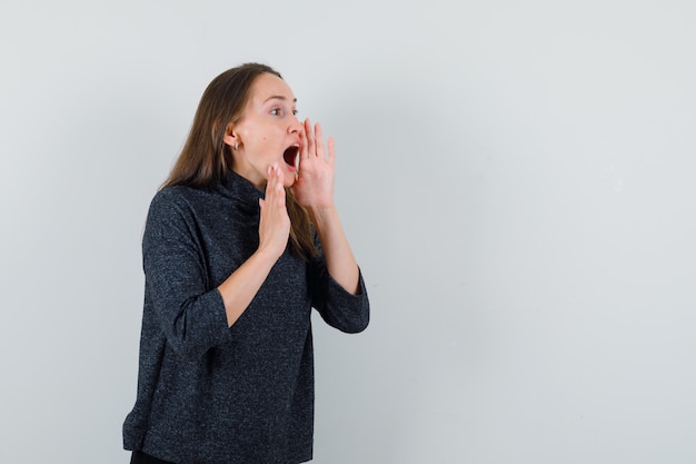 Free Photo | Young woman shouting with hand near mouth in shirt and ...