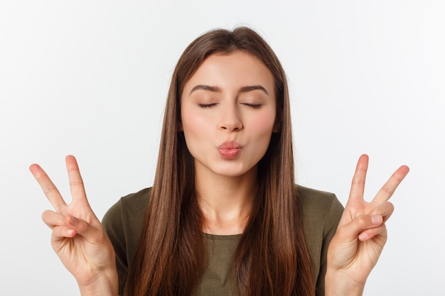 Premium Photo | Young woman showing two fingers, positive or peace ...