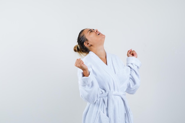 Free Photo Young Woman Showing Winner Gesture In Bathrobe And Looking Lucky 5539