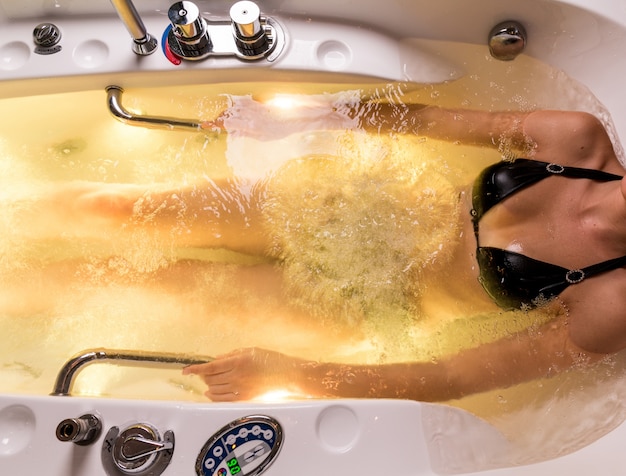 Young woman spends relaxing in the Jacuzzi Free Photo