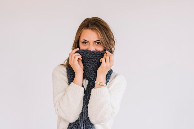 Free Photo | Young woman in sweater and scarf on face