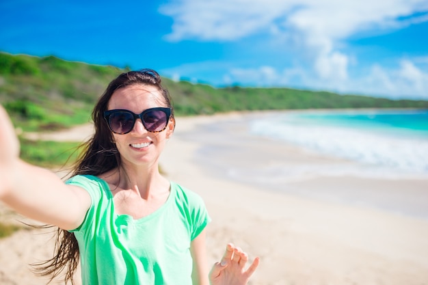 Premium Photo | Young woman taking selfie portrait on the beach