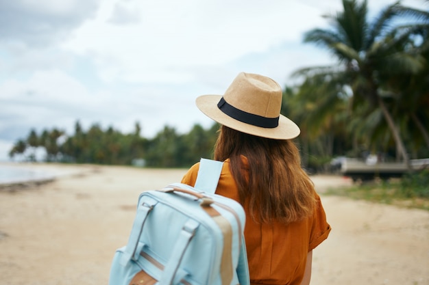 Premium Photo | Young woman in the tropical beach with palm trees