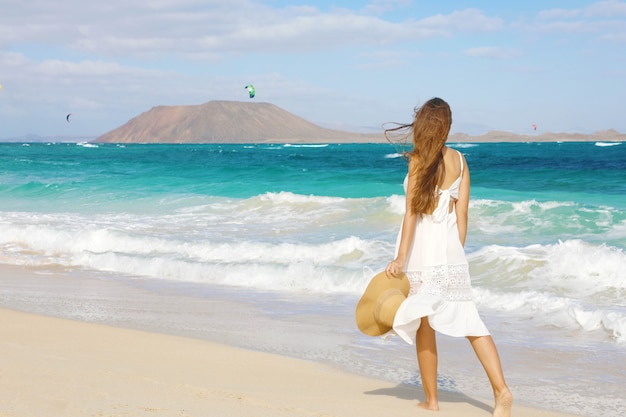 Premium Photo | Young woman walking on corralejo wild beach ...