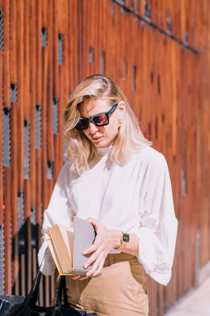 Free Photo | Young woman wearing sunglasses standing outside opening ...