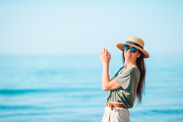 Premium Photo | Young woman in white on the beach