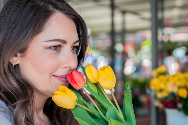 Free Photo Young Woman With Beautiful Bouquet Of Tulips On Flower Shop Background Portrait Of 