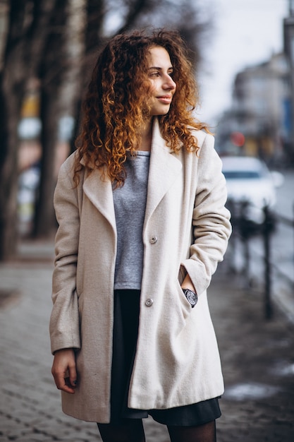 Young woman with curly hair outside the street Free Photo