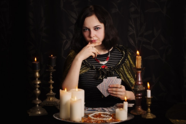 Young woman with divination cards in room Premium Photo