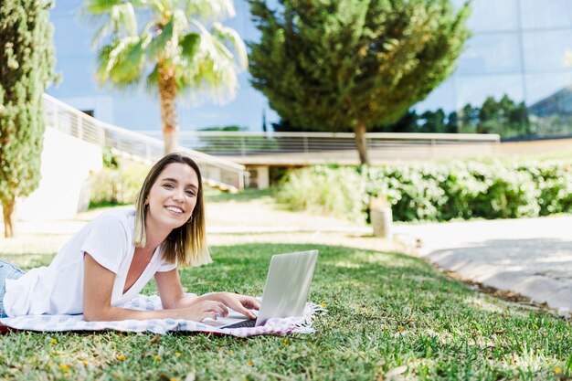 Free Photo | Young woman with laptop looking at camera