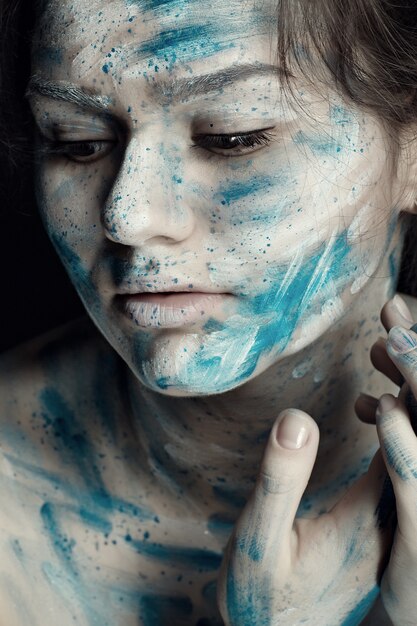 Premium Photo | Young woman with painted face