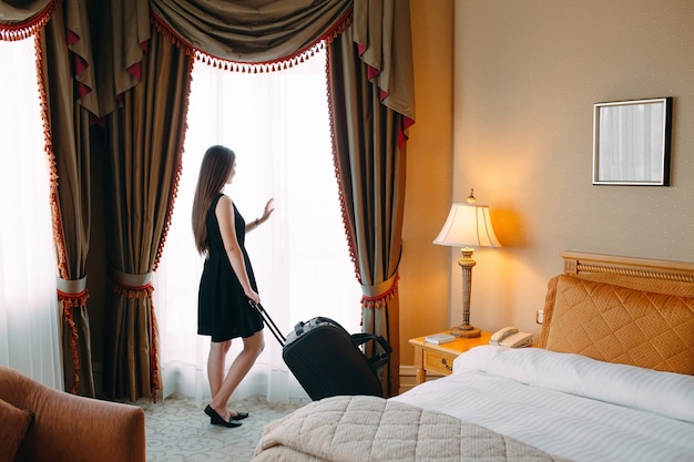 Young Women With Suitcase Are Staying In A Hotel Room Photo