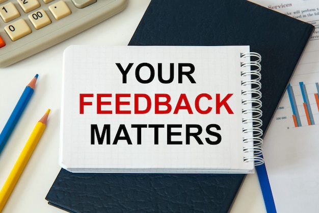 Premium Photo | Your feedback matters is written on a notepad with ...