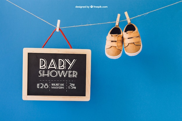 Download Free PSD | Baby mockup with shoes and slate on clothes line