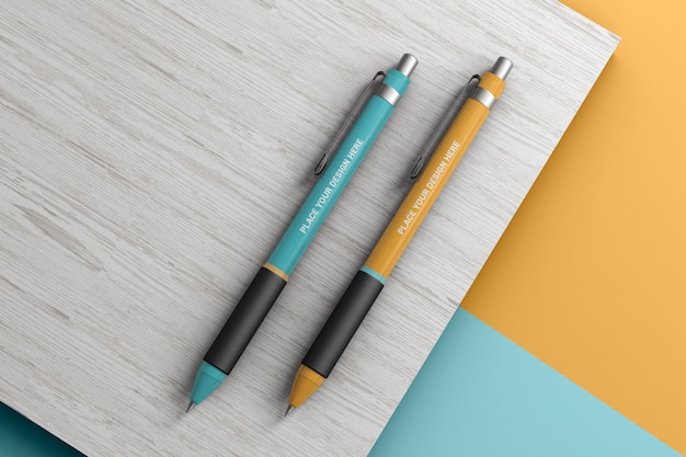 Download Premium PSD | Ballpoint pens on a wooden surface mockup