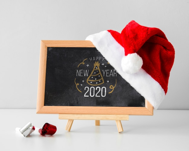 Download Black chalkboard mock-up with santa's hat | Free PSD File