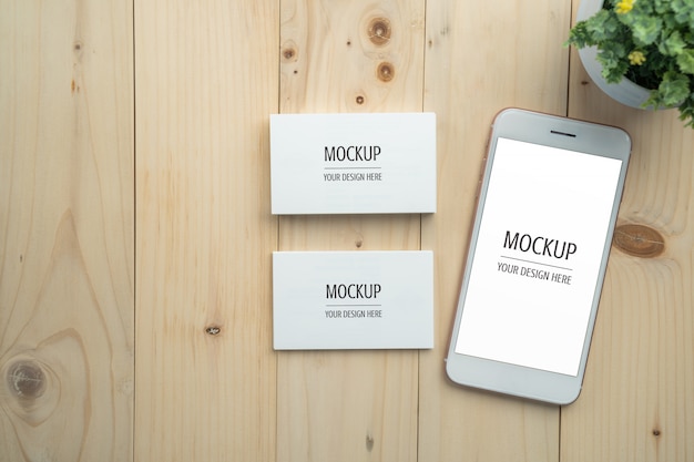 Download Blank white screen smartphone and business card mockup on wood table PSD file | Premium Download