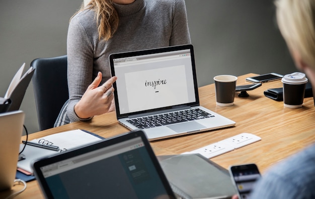 Blonde woman pointing at a laptop screen PSD Template