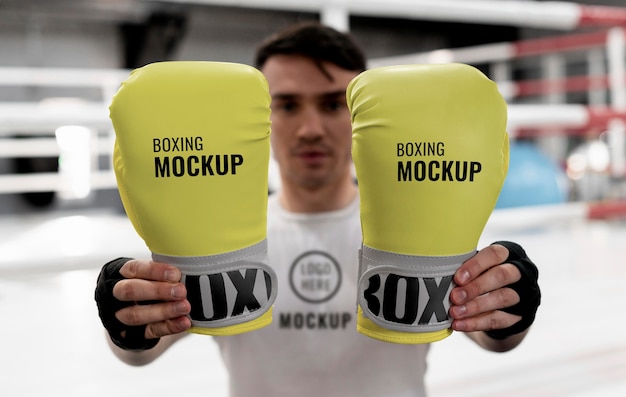 Free PSD | Boxing athlete holding mock-up gloves to train