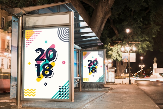 Download Bus stop billboard mockup in city at night PSD file | Free Download