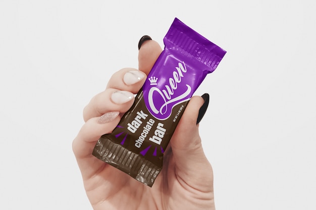 Download Chocolate bar in hand mockup | Premium PSD File