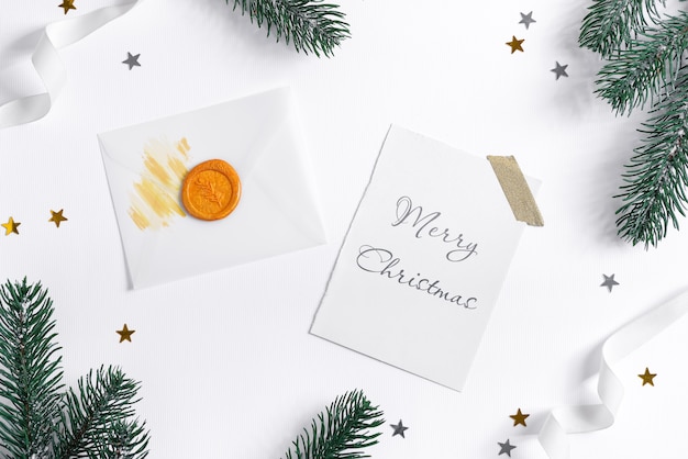 Download Premium PSD | Christmas card with fir twigs, confetti and mockup letter.