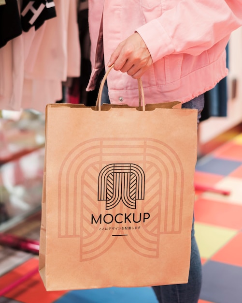 Download Premium PSD | Close-up person holding mock-up shopping bag