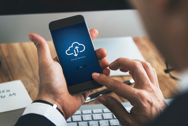 Closeup of businessman using smartphone with cloud computing symbol PSD Template