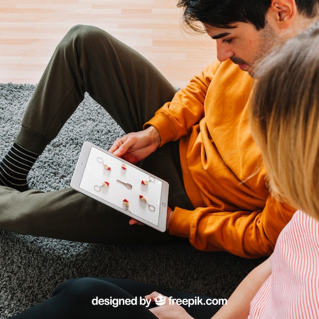 Couple looking at tablet PSD Template