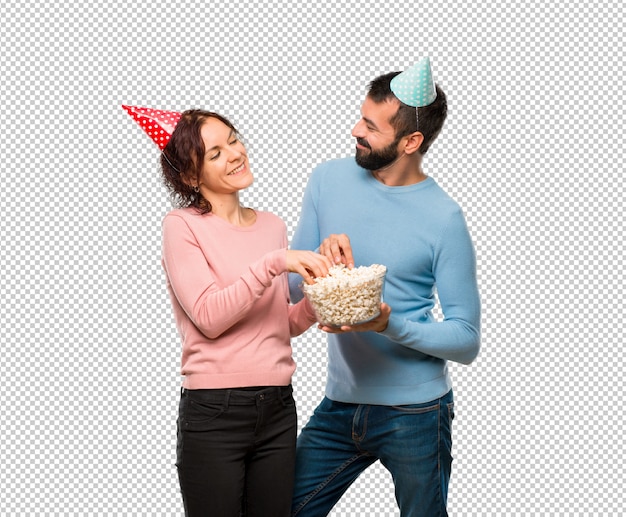 Download Premium PSD | Couple with birthday hats and eating popcorns