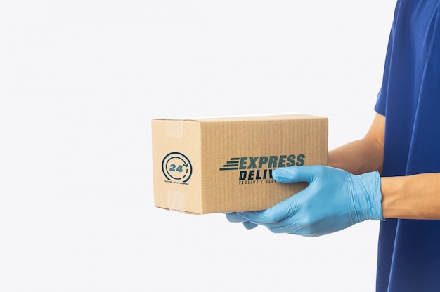 Download Premium PSD | Delivery man hand holding cardboard boxes mockup template for your design.