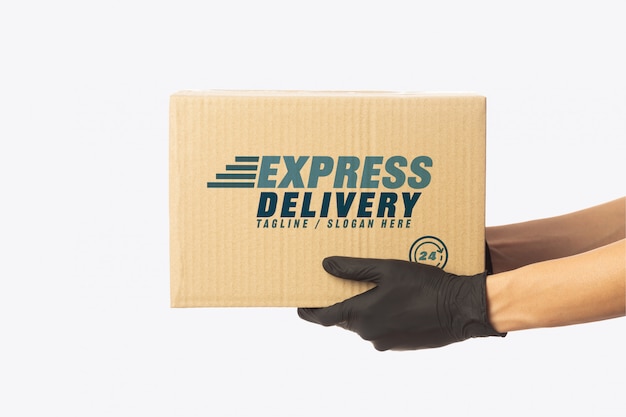 Download Premium PSD | Delivery man hand holding cardboard boxes mockup