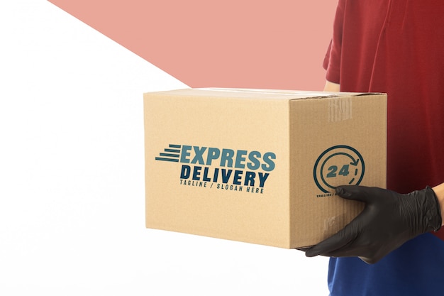 Download Premium PSD | Delivery man hand in medical gloves holding cardboard box mockup template.