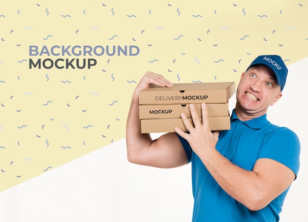 Download Free PSD | Delivery man holding a bunch of pizza boxes with background mock-up