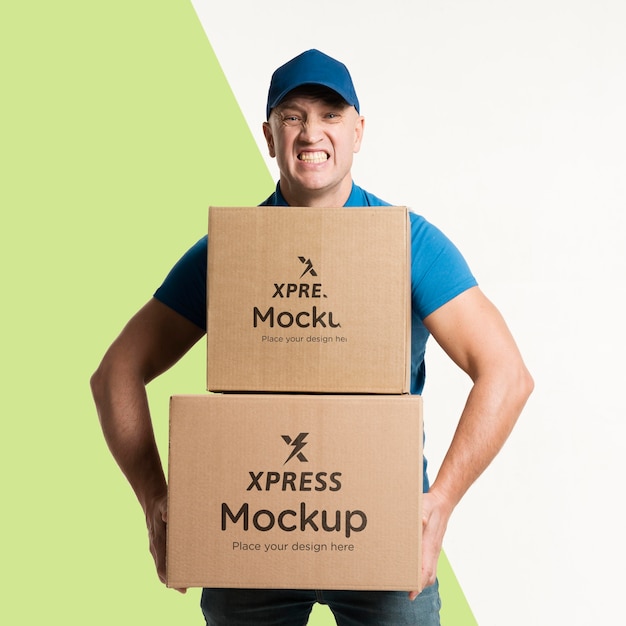 Download Free PSD | Delivery man holding some boxes mock-up