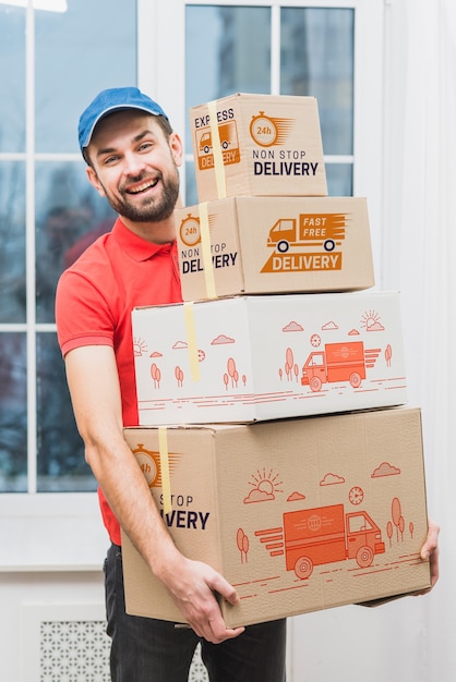 Download Delivery mockup with man holding boxes | Free PSD File