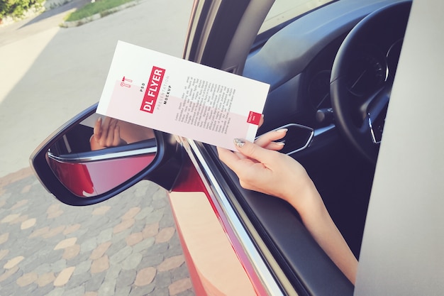 Download Dl flyer in hand sticking out of a car window mockup ...