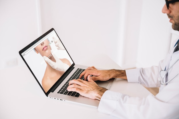 Doctor working with laptop PSD Template