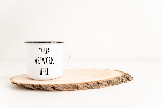 Download Premium Psd Enamel Mug Mockup With Wooden Cut Tree Section On White Table Boho Design Of Tin Cup