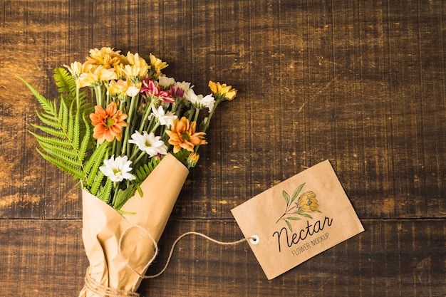 Download Flat lay bouquet of flowers with mock-up tag | Free PSD File