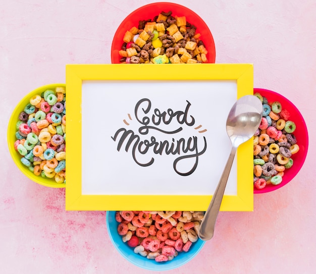 Flat lay of colorful cereals spoon and frame on plain background Free Psd