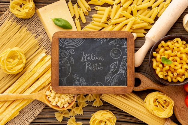 Download Flat lay uncooked pasta assortment with blackboard mock-up | Free PSD File