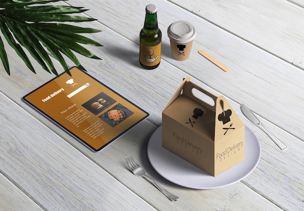 Free PSD | Food delivery with cardboard box and menú on wooden table